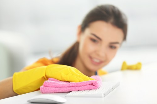 Staff member storing cleaning products securely and using protective gear